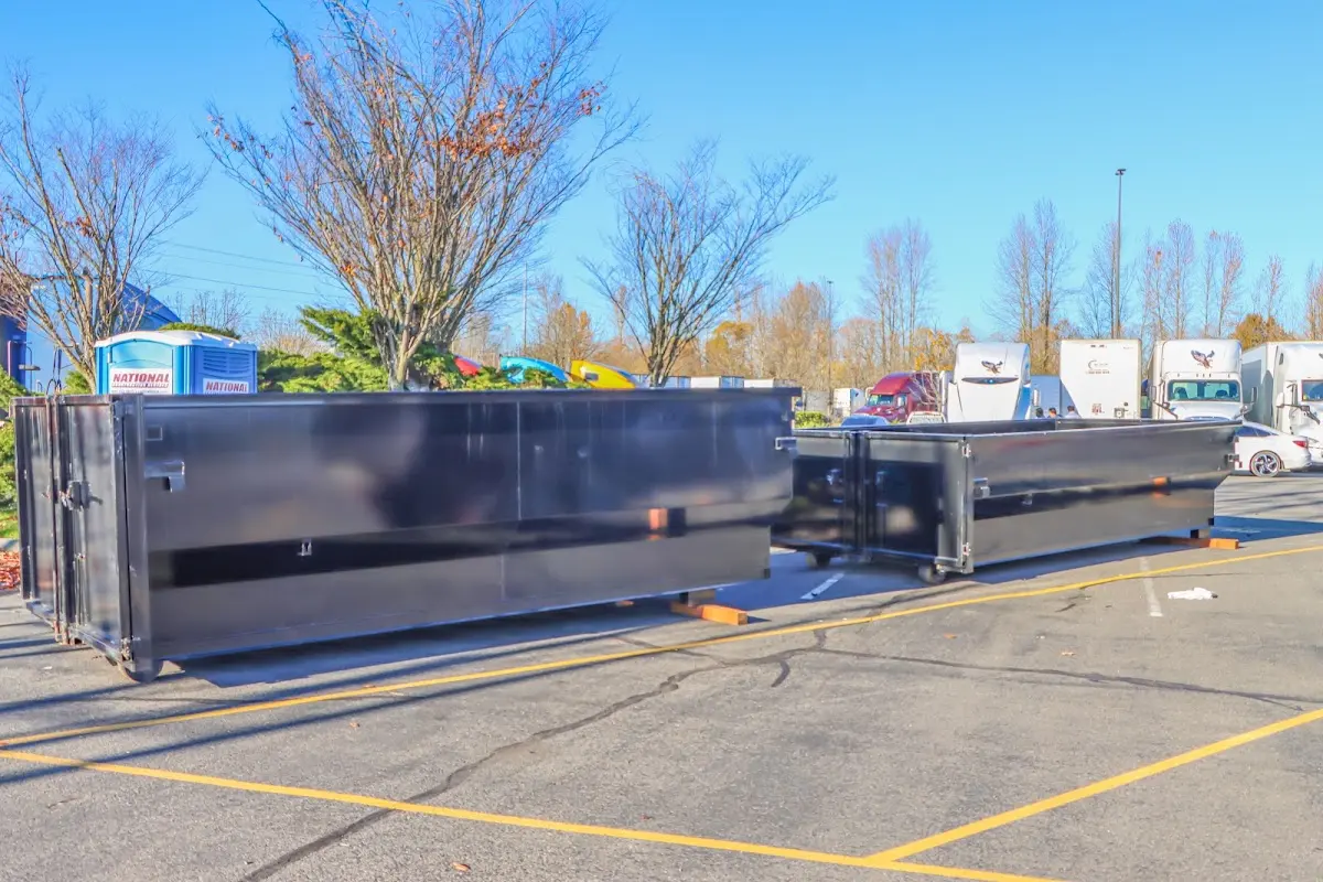 Professional dumpster rental service with roll-off container on residential driveway in El Reno